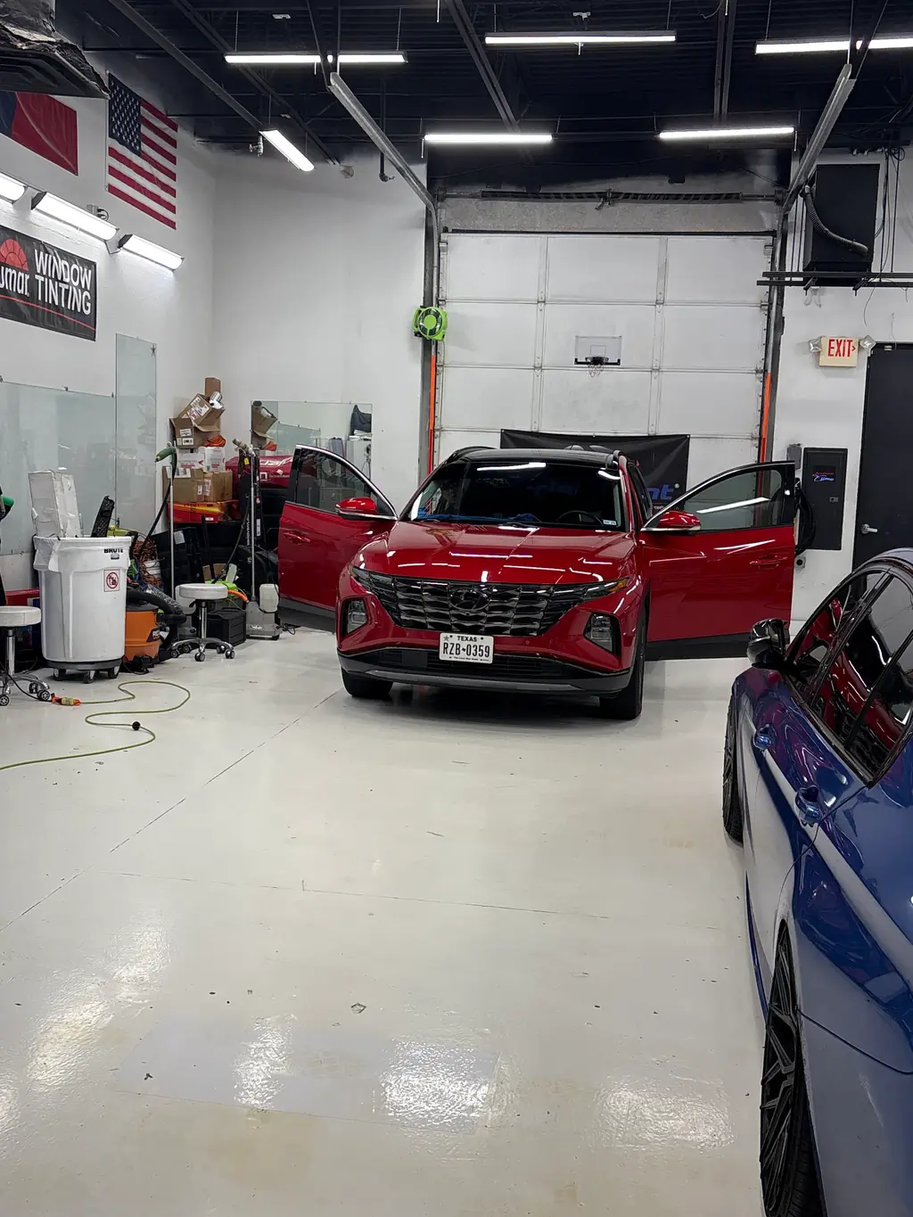 A vehicle in the Frisco Tint installation bay with the doors open